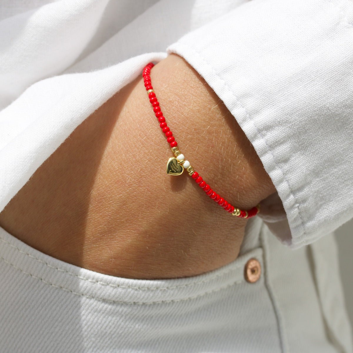 Red beaded bracelet for Gender Justice