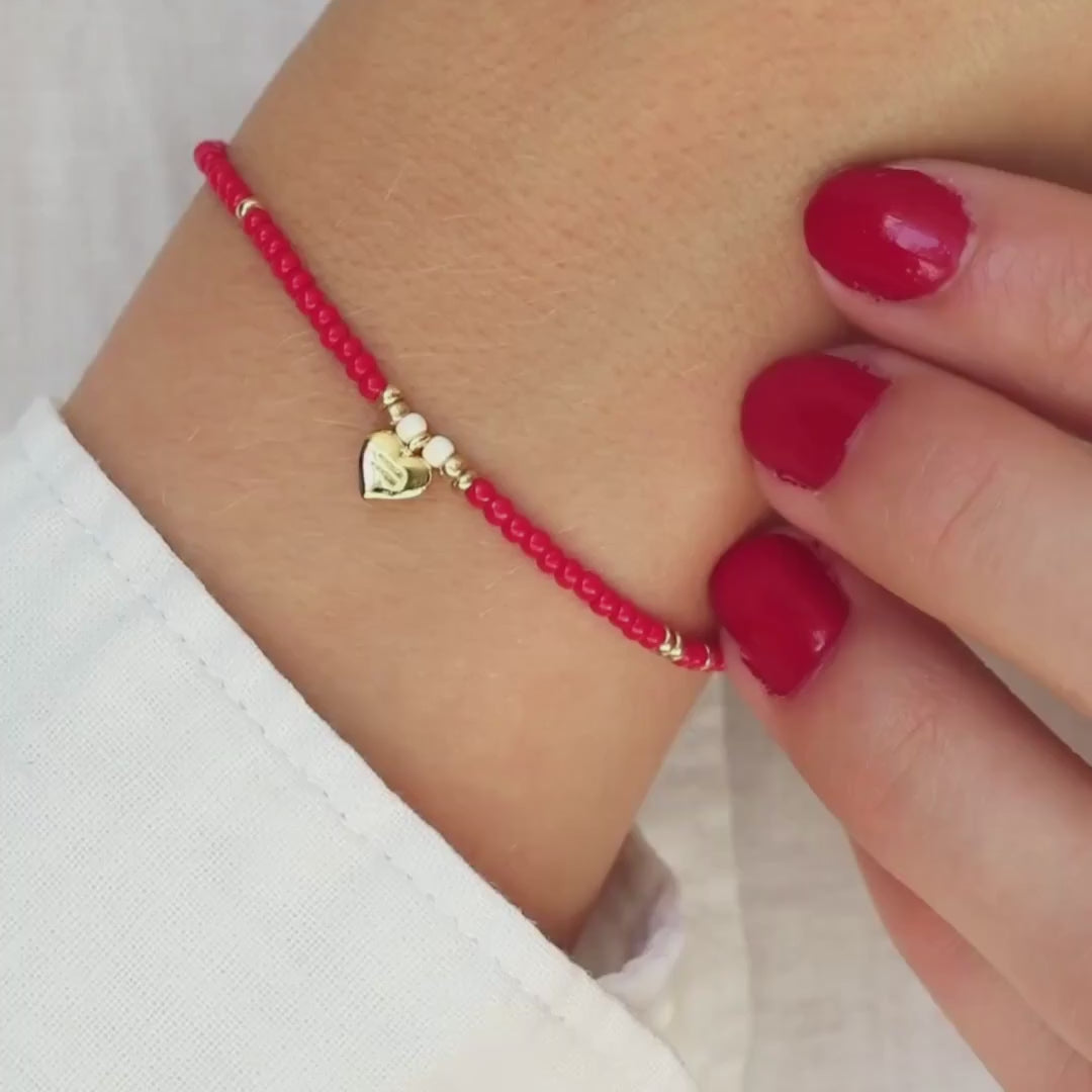Red beaded bracelet for Gender Justice